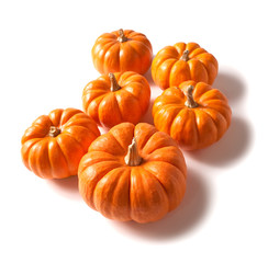 Six Small Pumpkins on White