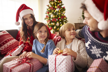 Fototapeta na wymiar Loving family with Christmas presents