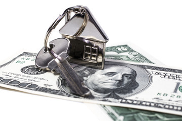 American dollars image, which is the key with remote control in the form of the house,  represents the purchase or sale  real estate and housing