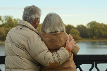 Happy senior couple  near river