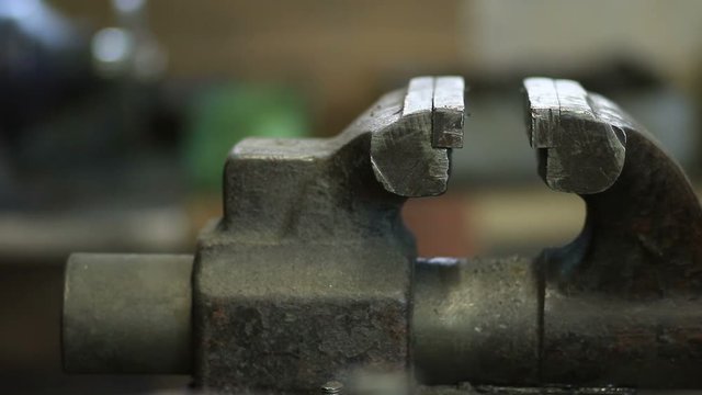 Old and rusty bench vise in metalwork workshop
