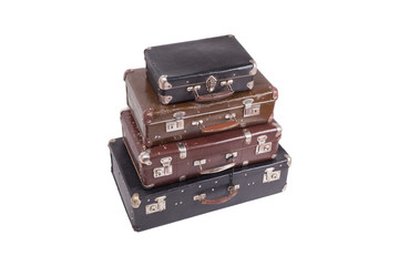 Stack of old vintage suitcases isolated on white