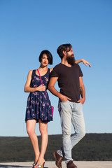 Couple pose on blue sky