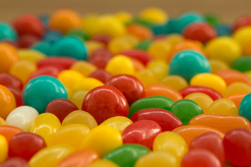 Colorful jelly beans close to wallpaper