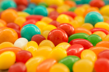 Fototapeta na wymiar Colorful jelly beans close to wallpaper