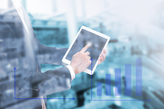 Double exposure of businessman using the tablet with business graph on blur image of shopping department store , Management Information Technology concept