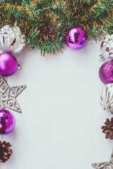 New year theme: Christmas tree purple and silver decorations, balls on white retro wood background