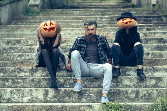 halloween man and girls with pumpkin