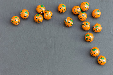 Halloween pumpkin candy balls on slate.