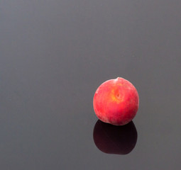 Fresh Organic Peach on a Glass Table