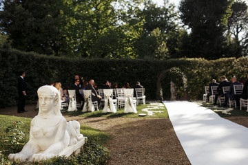 White Egypt figure stands in the green garden prepared for weddi