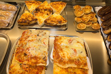 Closeup of cooked pizza slices in a bakery