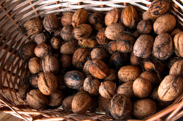 Walnuts in wicker basket. Copyspace