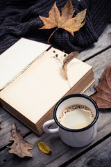vintage book, knitted sweater with autumn leaves and coffee mug