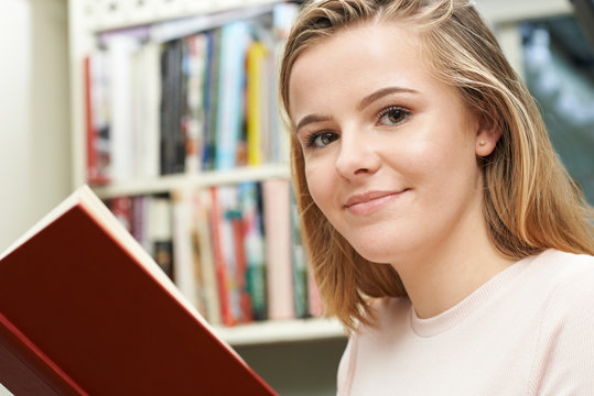 Teenage Girl Reading Book At Home