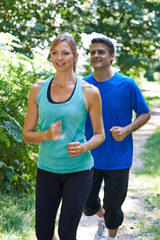 Mature Couple Running In Countryside