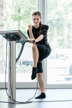 Woman having training session in EMS gym for better fitness