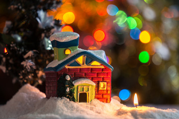 Winter background. Christmas background. Christmas snowman and candles. Close-up. Night Photography.