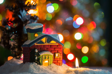 Winter background. Christmas background. Christmas snowman and candles. Close-up. Night Photography.