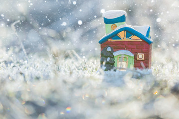 Christmas toy house on the grass frosted