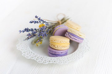 Several maсarons on white lace plate