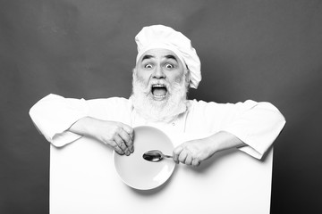 Bearded cook with paper spoon and plate