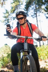 Fototapeta na wymiar Mountain biker using mobile phone