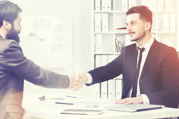 Businesspeople shaking hands and smiling