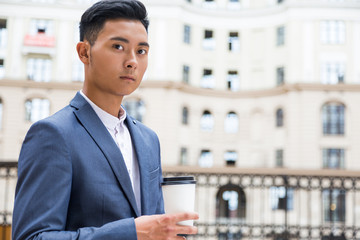 Asian businessman drinking his coffee