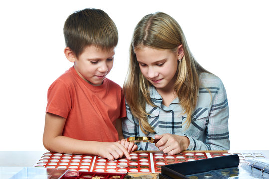 Boy and girl are considering coin collection isolated