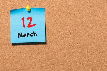 March 12th. Day 12 of month, calendar on cork notice board background. Spring time, empty space for text