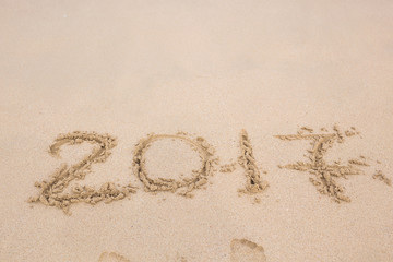 inscription 2017 on a beach sand