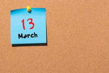 March 13th. Day 13 of month, calendar on cork notice board background. Spring time, empty space for text