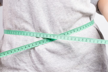 Woman measuring her waist