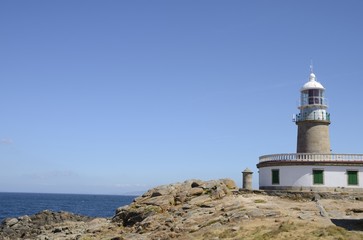 Fototapeta na wymiar Lighthouse in the Galician coast in Corrubedo, Spain.