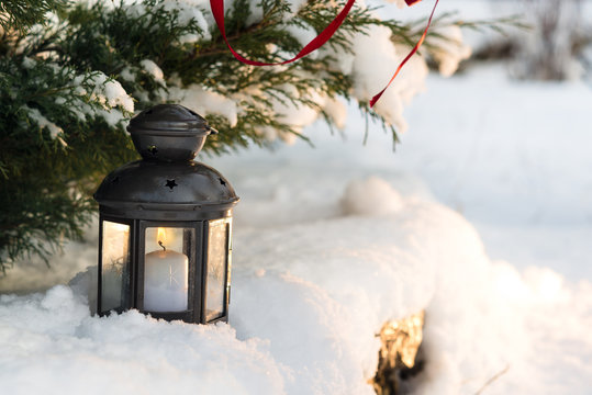 Christmas Lantern On Snow With Fir Branch outdoor closeup