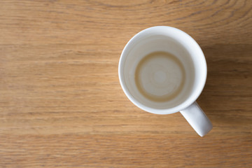 Closeup one coffee cup of hot black cappuccino on clean wooden table