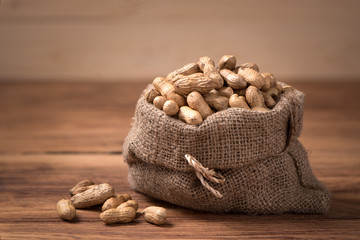 peanuts in sack on wood table