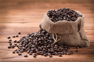 coffee bean in sack on wood table background