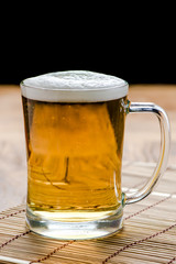 Beer in mug glass on wood table,top view