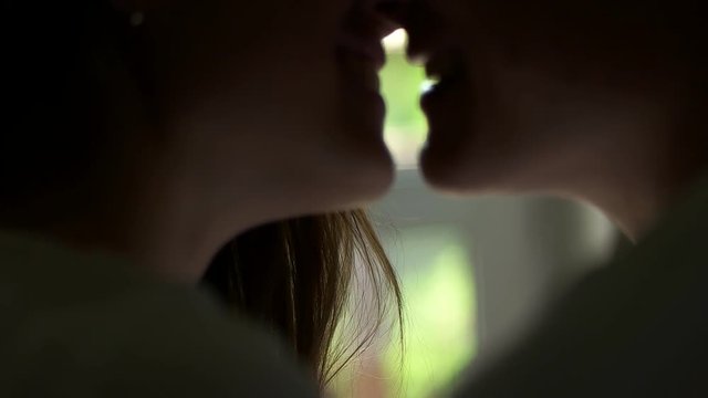 couple kissing close up on window background.