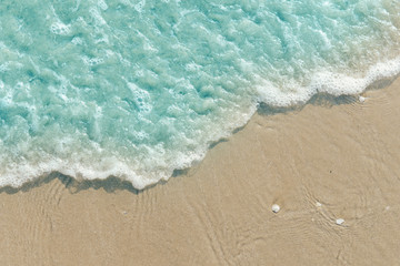 Fototapeta na wymiar Turquoise ocean wave on the sand beach, summer sea background