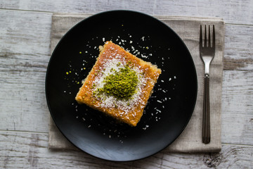 Turkish Dessert Revani with pistachio powder.