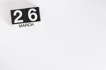 March 26th. Day 26 of month, wooden color calendar on white background. Spring time, empty space for text