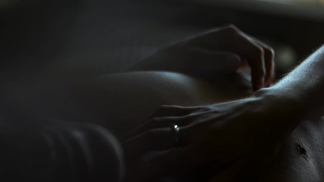 Girl stroking a guy in bed.