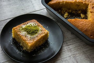 Turkish Dessert Revani with pistachio powder.