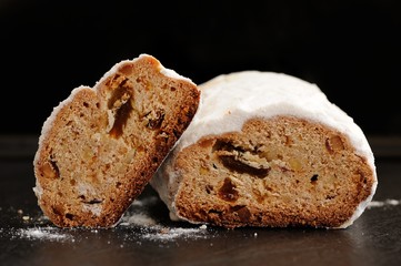 Stollen with raisins on black background