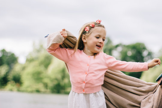 Girl spinning around holding a blanket