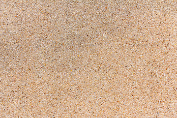 Fototapeta na wymiar Wall of small sand stone texture. Pebbles and sand wall texture.