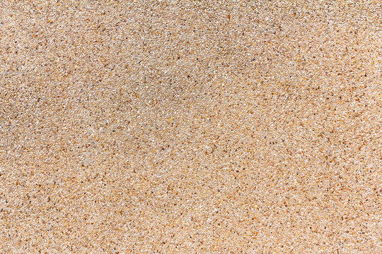 Wall of small sand stone texture. Pebbles and sand wall texture.